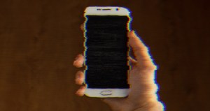 A person holds a cellphone in their hand.