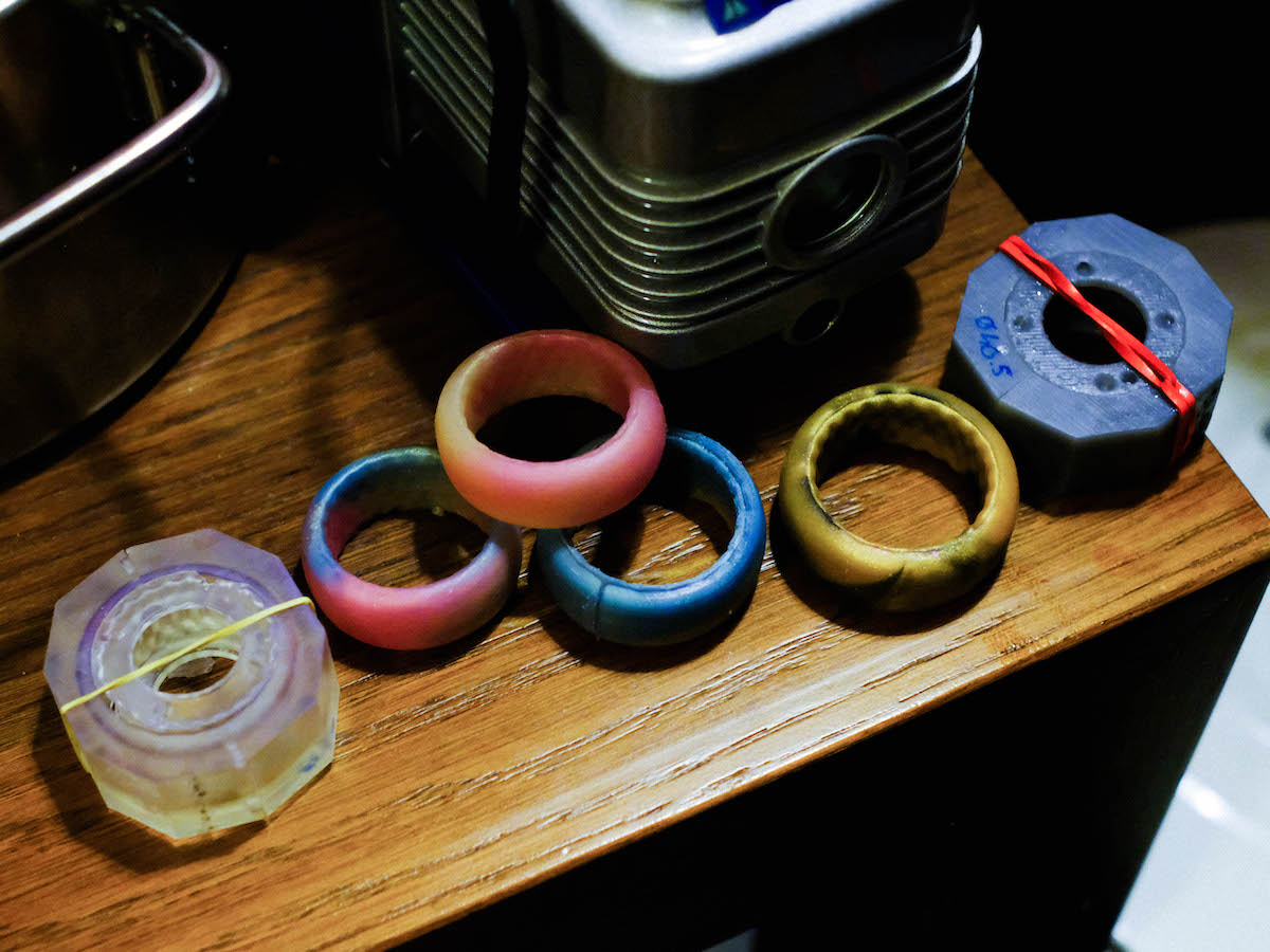 Heat-based Otoko Contraception – Four silicon rings and two moulds held together by elastics in tones of red, blue, yellow and green.