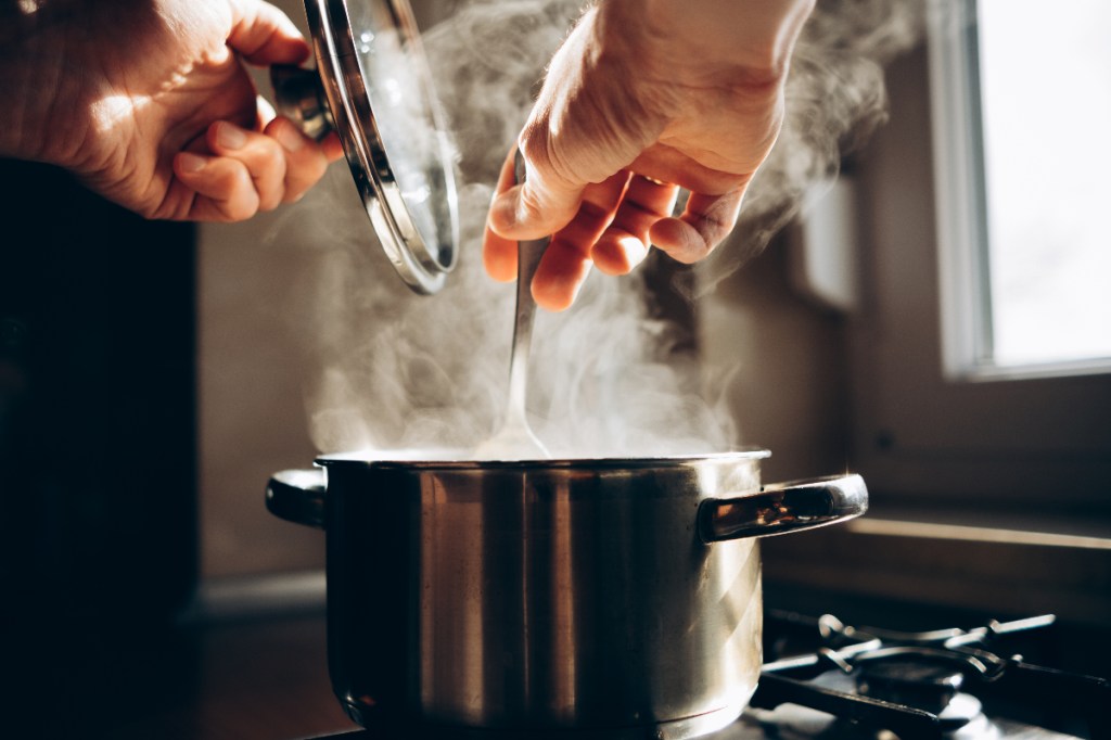 man stirring pot