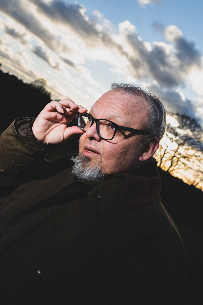 A man adjusts his glasses